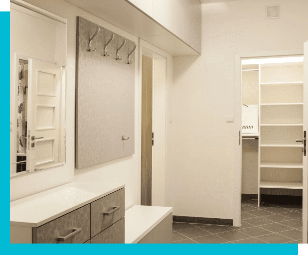 A hallway interior with a coat rack, a mirror, a cabinet, and a door leading to a room with white shelves. The walls are white, and the floor is tiled.